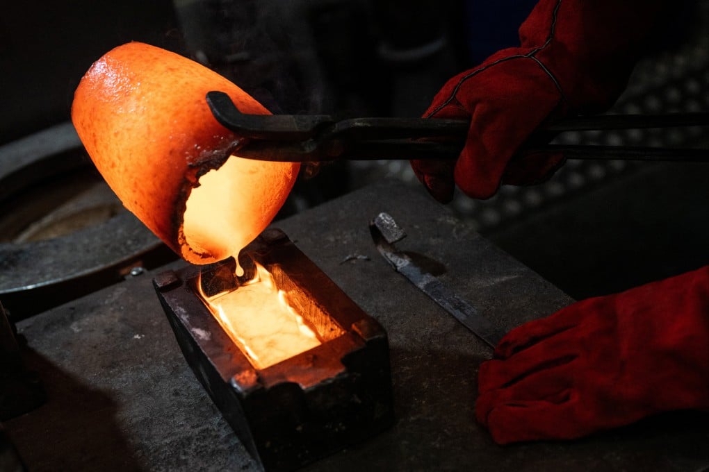 Melted gold coins and jewellery are poured into a casting mould at Baird & Co., the United Kingdom’s largest independent gold trader and refinery, in London on April 22. Photo: Reuters