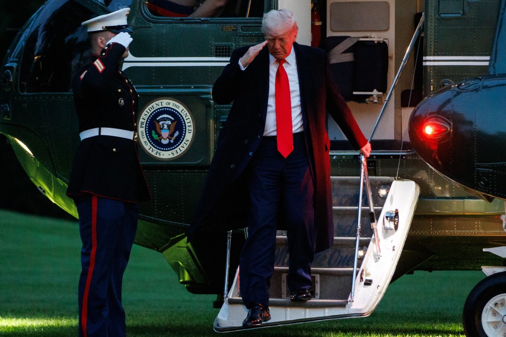 US President Donald Trump steps off Marine One after landing on the South Lawn of the White House on Thursday. Photo: EPA-EFE