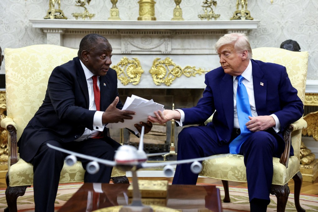 US President Donald Trump hands over to South African President Cyril Ramaphosa copies of articles that he said showed white South Africans who had been killed, in the Oval Office of the White House in Washington on May 21. Photo: Reuters