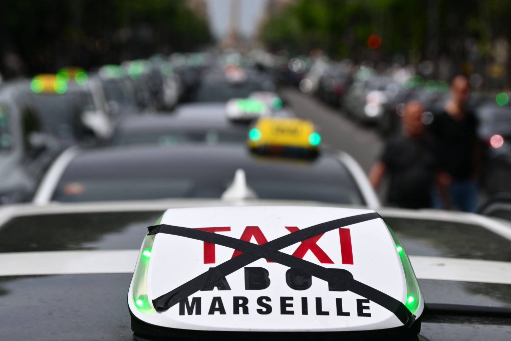 A Taxi light is crossed out as taxi drivers take part in a blocking operation during a nationonwide protest against proposed changes in how the state finances medical transport services, in Marseille on Monday. Photo: AFP