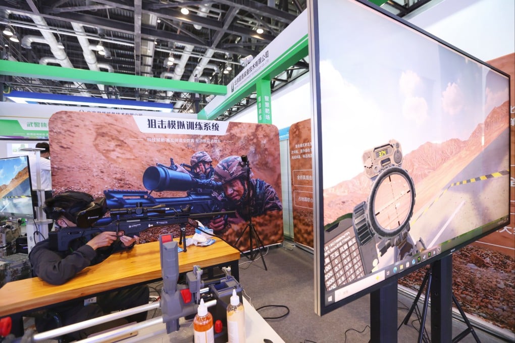 A visitor tries a sniper simulation training system during the 10th China (Beijing) Military Intelligent Technology Expo in Beijing on May 15. Photo: China News Service via Getty Images