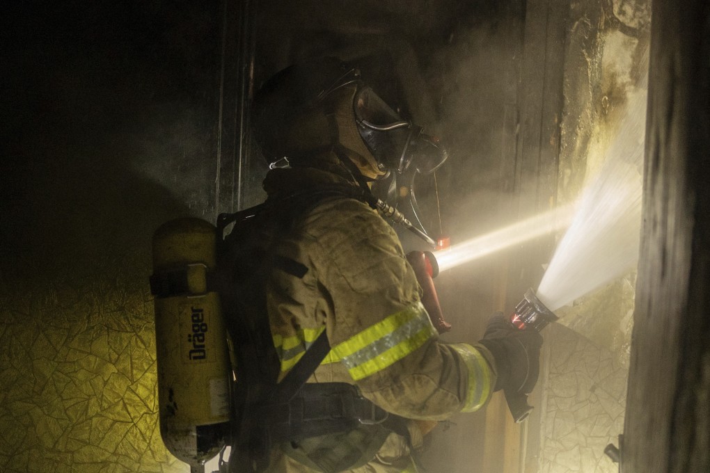 Firefighters extinguish a fire in a residential building damaged by a Russian attack in Kyiv on Saturday. Photo: AP