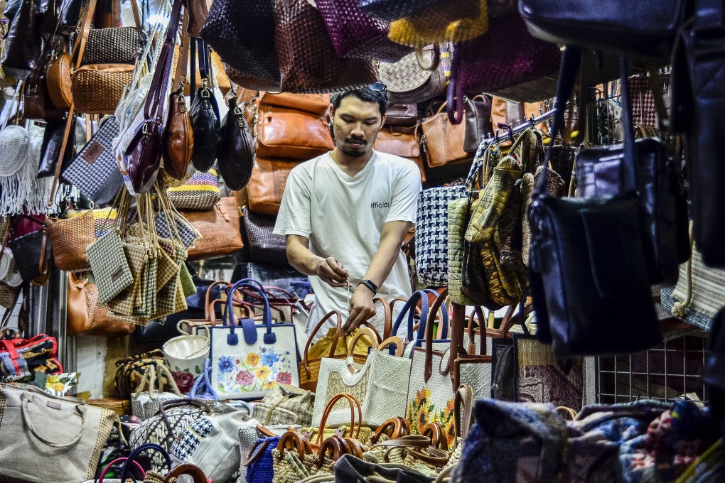 A merchant checks bags displayed at his stall at Beringharjo traditional market in Yogyakarta on May 5. Indonesia posted an economic growth rate of 4.87 per cent year-on-year in the first quarter of 2025, according to official data. Photo: Xinhua