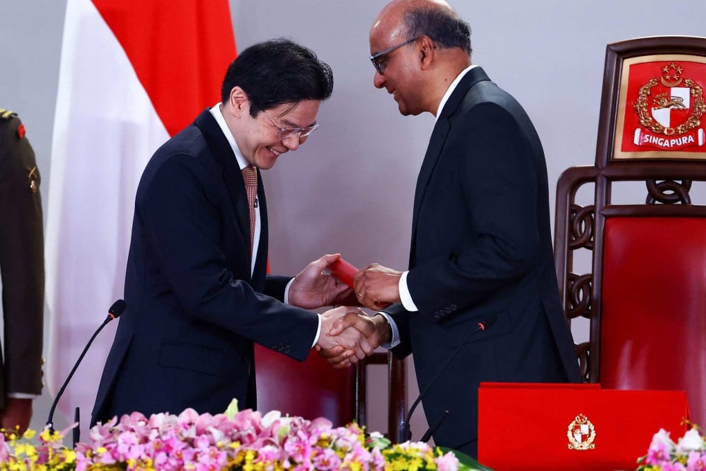 Singapore’s Prime Minister Lawrence Wong (left) shakes hands with President Tharman Shanmugaratnam during the swearing-in ceremony at the Istana on Friday. Photo: AFP