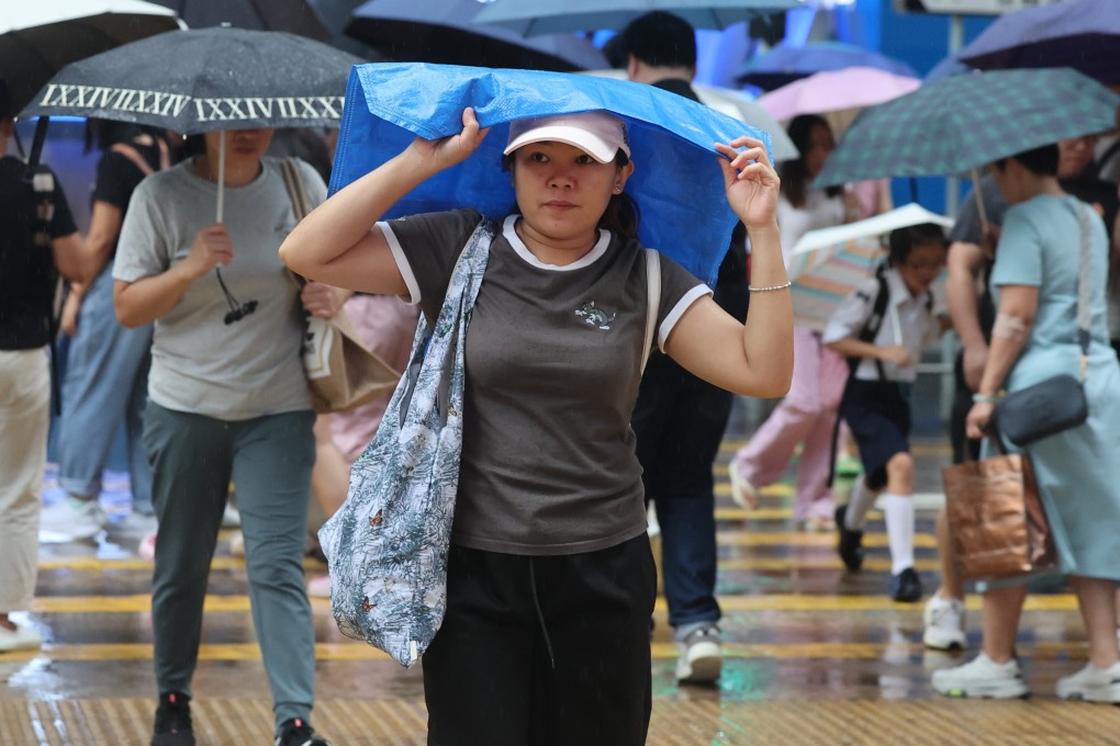 Residents cross the street in Central during a rainy spell. Photo: Edmond So