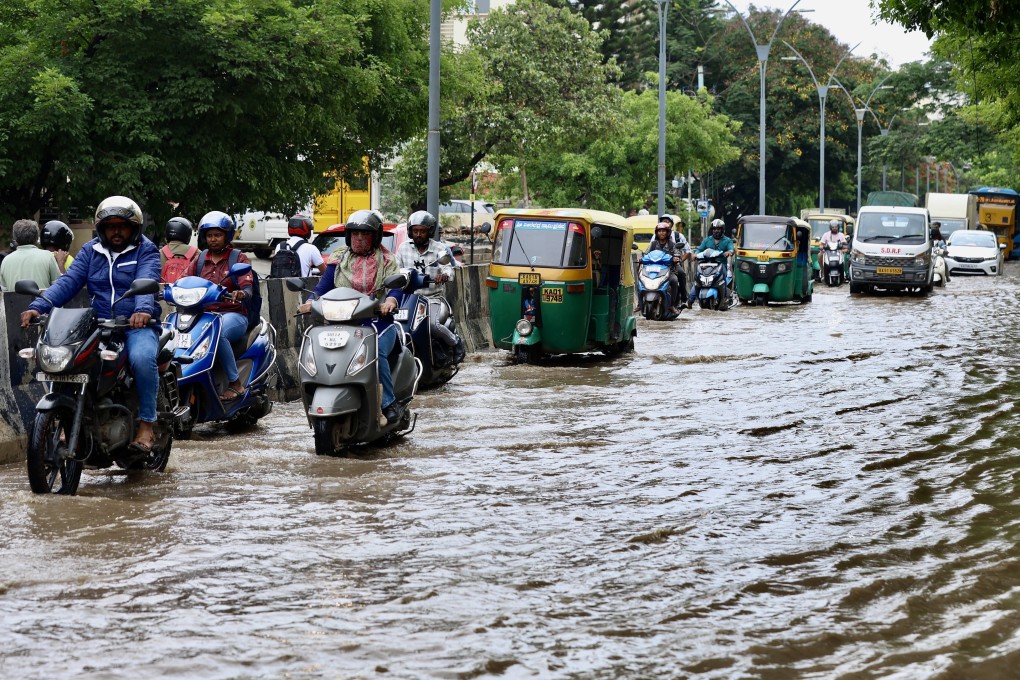 Motorists drive through a waterlogged street following heavy rainfall in Bengaluru, India, on Tuesday. Photo: EPA-EFE