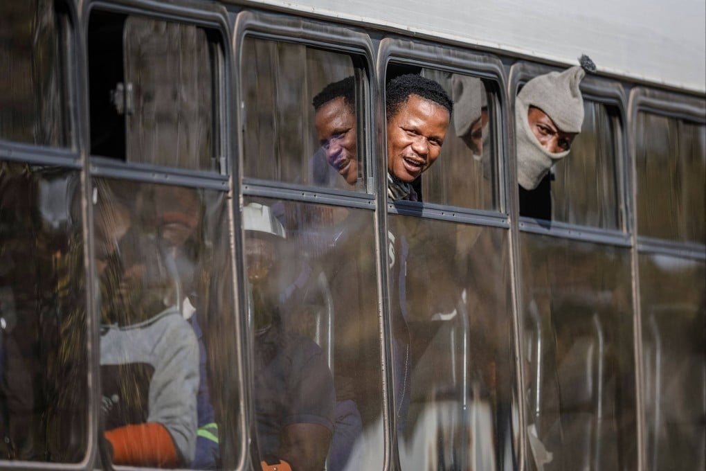 Some of the rescued workers sit inside a bus as they leave the Kloof gold mine in Westonaria on Friday. Photo: AFP