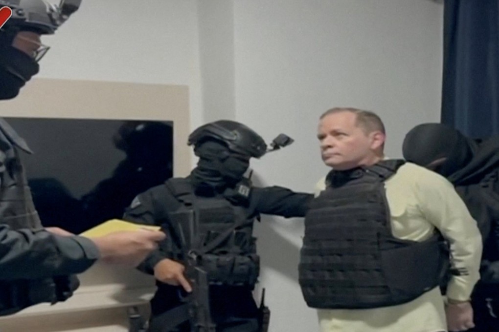 Venezuela opposition leader Juan Pablo Guanipa, wearing a bulletproof vest, is  handcuffed, after being detained by Venezuelan law enforcement officers On Friday. Photo: Venezualan Government TC/Reuters on May 23, 2025.