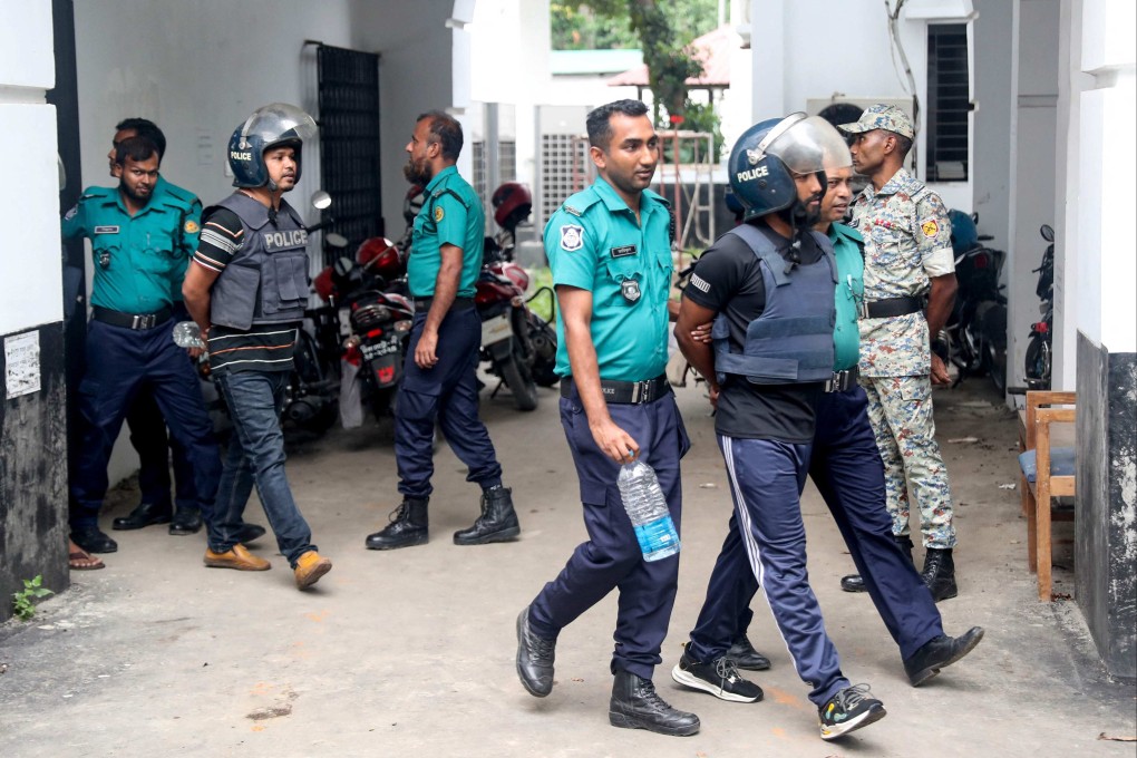 Police personnel escort detained policemen charged with crimes against humanity to the International Crimes Tribunal ICT court in Dhaka on Sunday. Photo: AFP