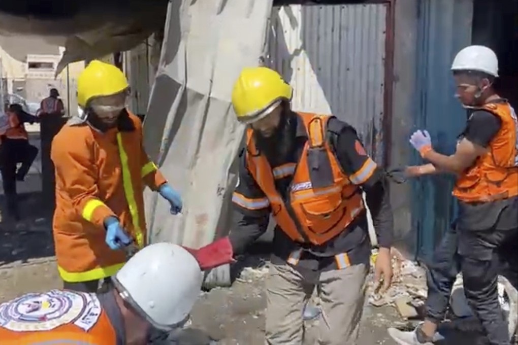 Workers collect human remains after an Israeli strike on a home in Khan Younis killed nine of a doctor’s 10 children while she was at work. Photo: Gaza Civil Defence via AP