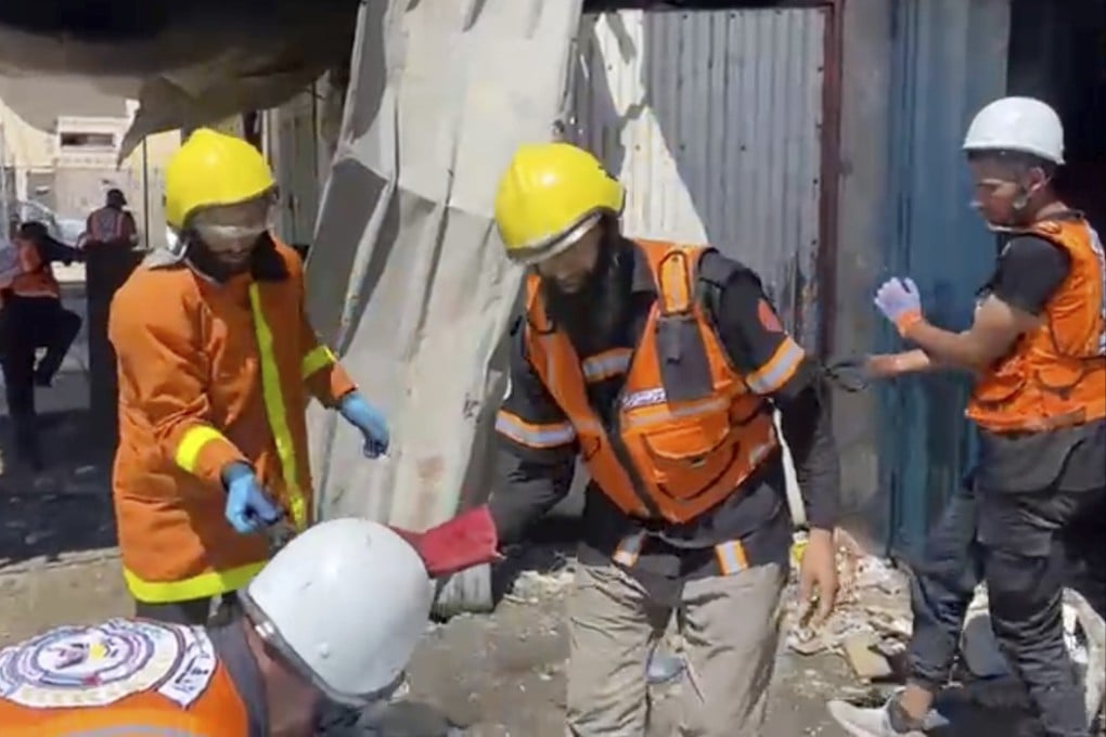 Workers collect human remains after an Israeli strike on a home in Khan Younis killed nine of a doctor’s 10 children while she was at work. Photo: Gaza Civil Defence via AP