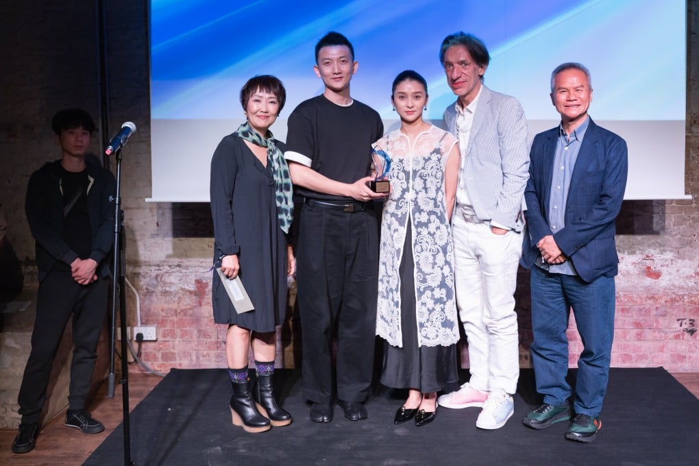 Hong Kong Ballet’s Ricky Hu Songwei (second from left), Ma Jingwen (centre) and Septime Webre (second from right) receive the 2025 Hong Kong Dance Awards prize for best choreography from Olivia Yan and Tang Shu-wing, one of six the company took home. Photo: Hong Kong Dance Alliance