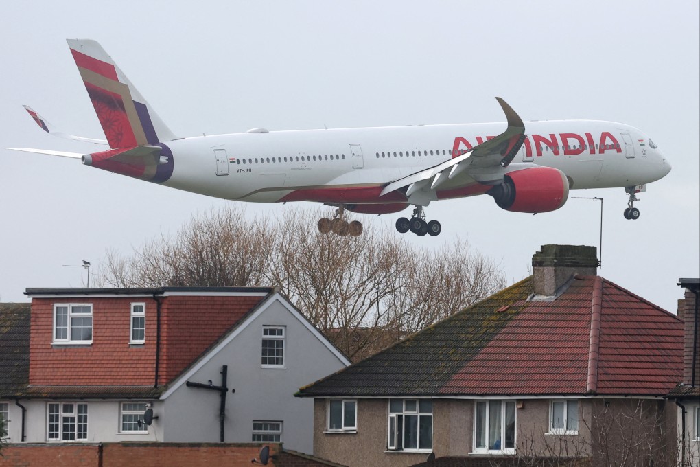 An Air India passenger plane flies near houses as it makes its landing approach at Britain’s Heathrow Airport in west London. Photo: Reuters