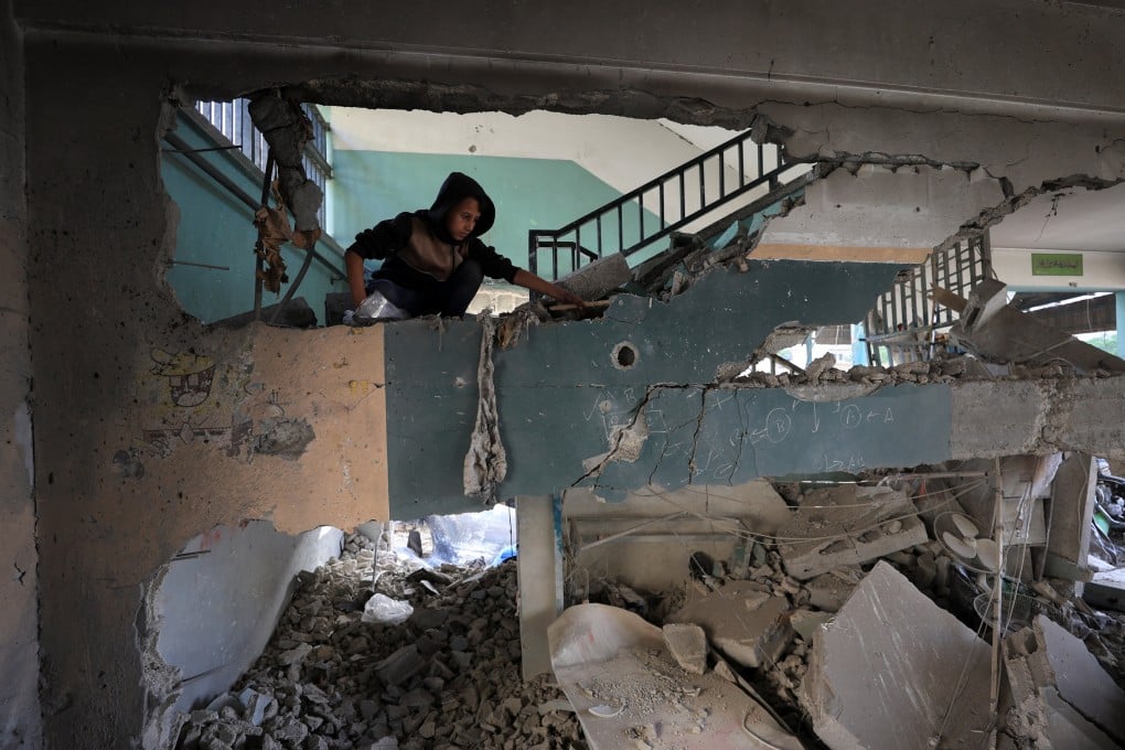 A Palestinian inspects the damage at a Gaza City school that sheltered displaced people, following an Israeli strike. Photo: Reuters