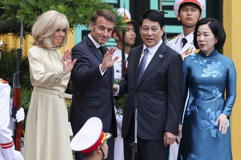 Vietnam’s President Luong Cuong and his wife Nguyen Thi Minh Nguyet welcome French President Emmanuel Macron and his wife Brigitte Macron at the Presidential Palace in Hanoi on Monday. Photo: AP