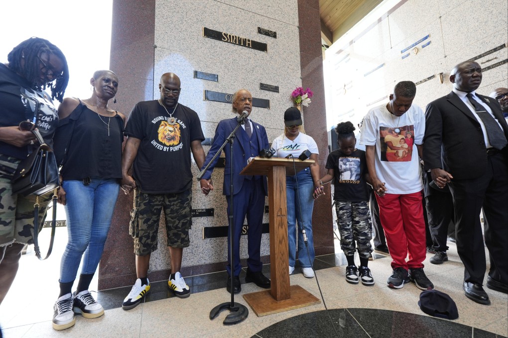 Reverend Al Sharpton prays with family members of George Floyd on Sunday in Houston, Texas. Photo: AP