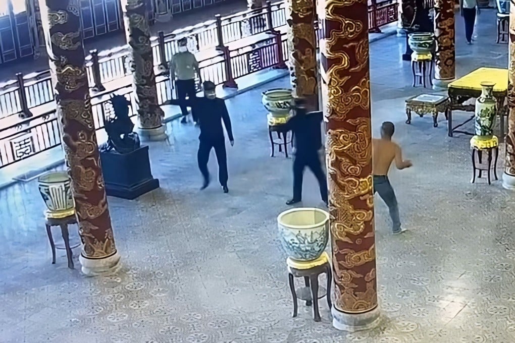 A still image from security footage circulated on social media shows a shirtless man confronting guards within Thai Hoa Palace, Vietnam. Photo: Facebook/LeThanhPhong