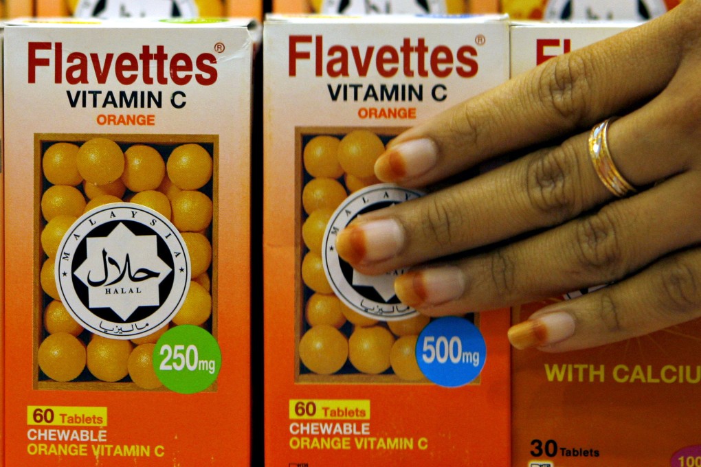 Vitamin C bottles are seen in Malaysia carrying a halal decal, assuring customers the product was prepared according to proper Muslim rites. Photo: AFP
