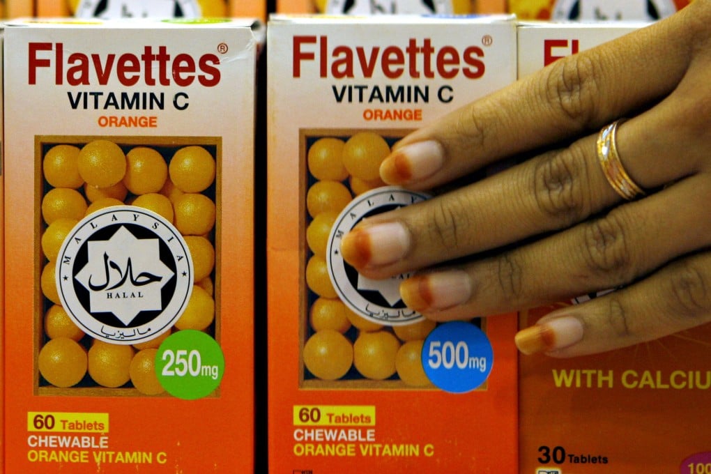 Vitamin C bottles are seen in Malaysia carrying a halal decal, assuring customers the product was prepared according to proper Muslim rites. Photo: AFP