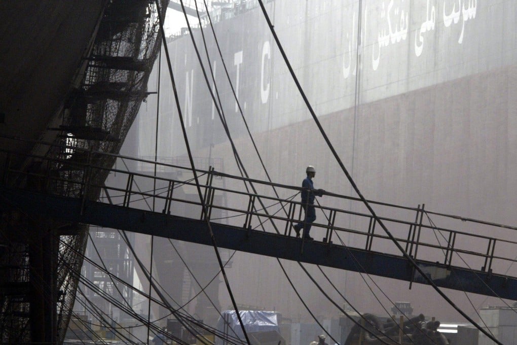 A worker walks off a vessel being built in a shipyard in Dalian, China’s Liaoning province, in 2004. China has become a shipbuilding powerhouse in recent decades. Photo: EPA-EFE