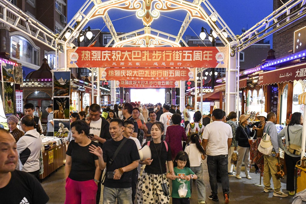 Tourists shop in the Grand International Bazaar in the capital of the Xinjiang Uygur autonomous region. The region in western China plans to open up to more foreign tourism to diversify its economy. Photo: Xinhua