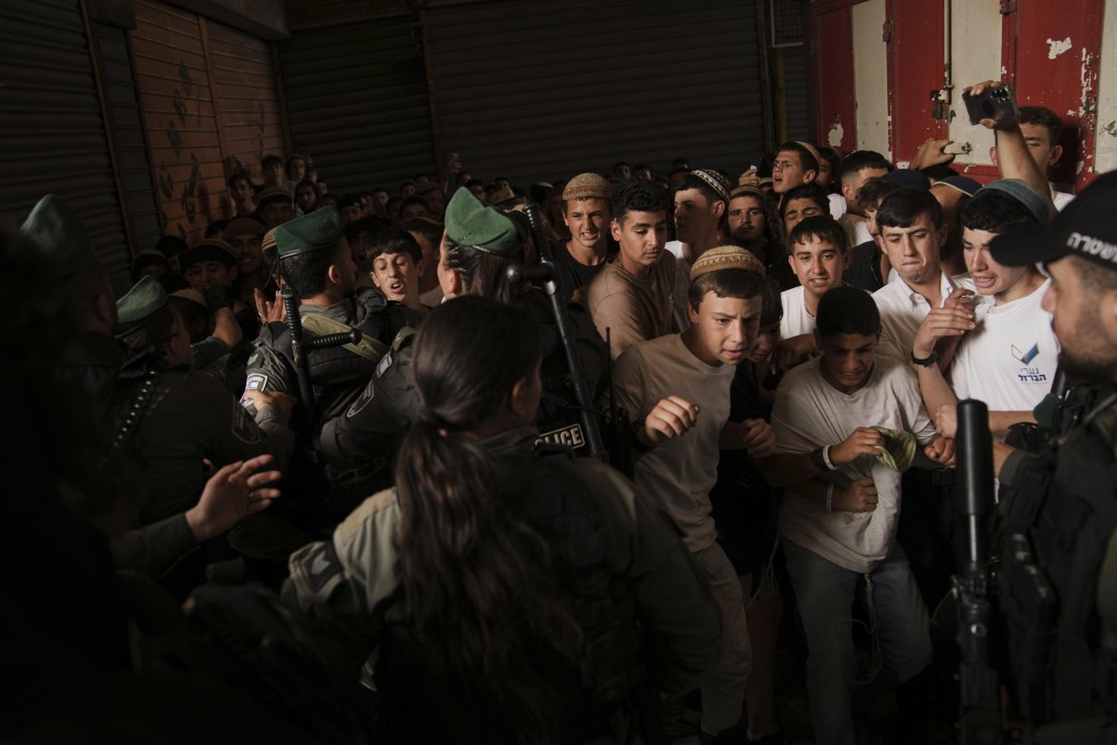 Israeli police scuffle with young Israelis marching through Jerusalem’s Old City, marking Jerusalem Day. Photo: AP