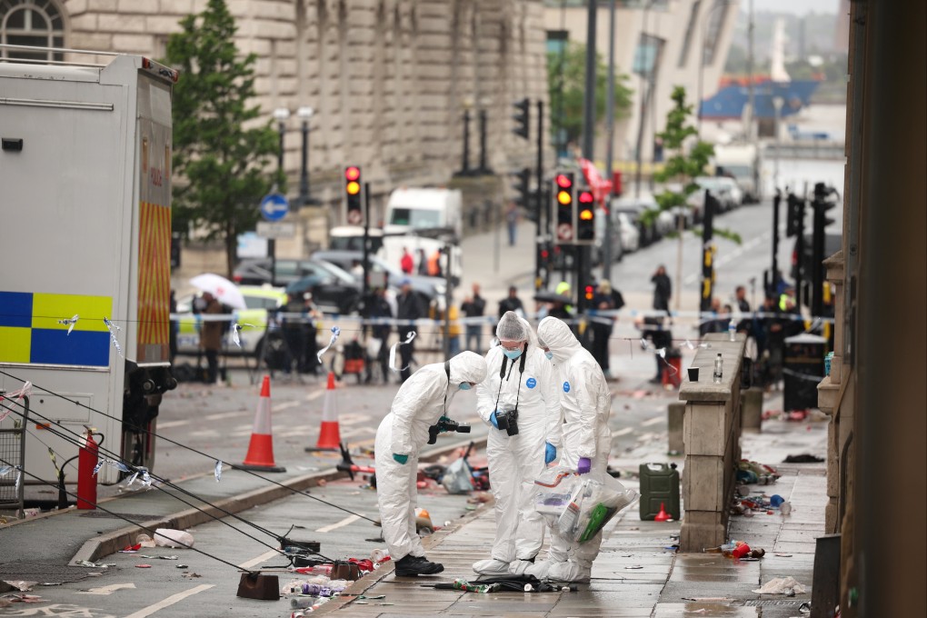 Forensics officers at the scene where a car collided with people during the Liverpool FC trophy parade in Britain on Tuesday. Photo: EPA-EFE