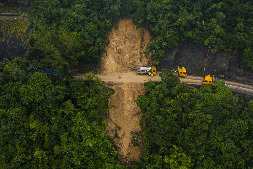 A landslide is cleared by workers on a road leading to Shek O and Big Wave Bay in Hong Kong in September 2023. Photo: AFP