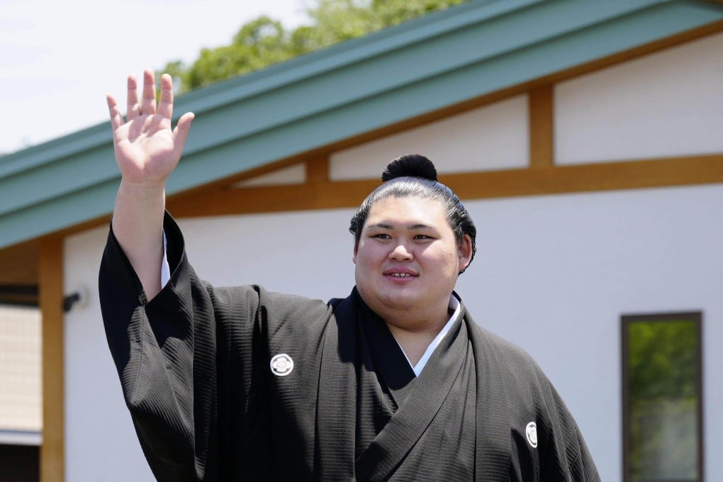 Onosato waves to fans at his stable in Ami in the Japan prefecture of Ibaraki on Wednesday after his promotion to the sport’s highest rank of yokozuna, or grand champion. Photo: Kyodo