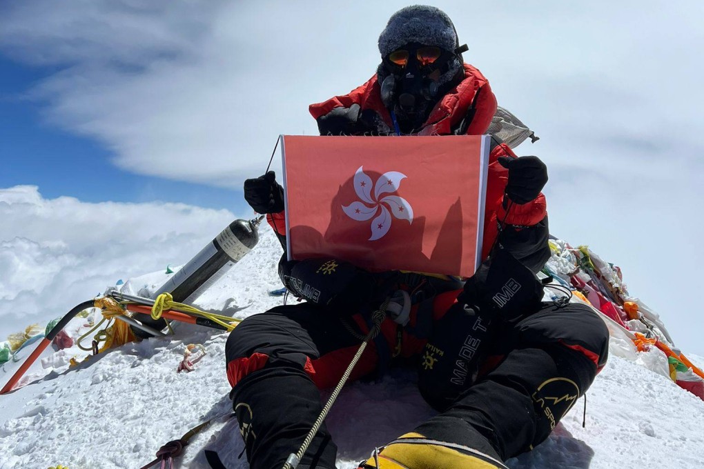 Raj Gurung poses at the summit of Mount Everest with a Hong Kong flag. Photo: Dreamers Destination Treks & Expedition