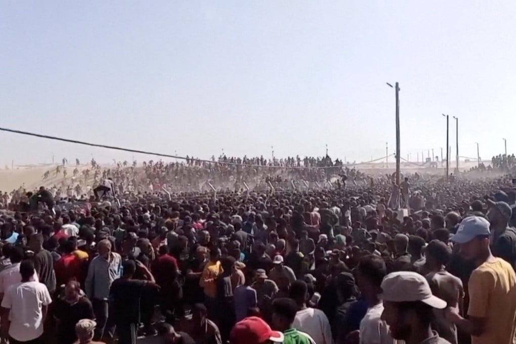Palestinians rush to get aid boxes in Rafah, in the southern Gaza Strip, on Tuesday. Photo: Reuters