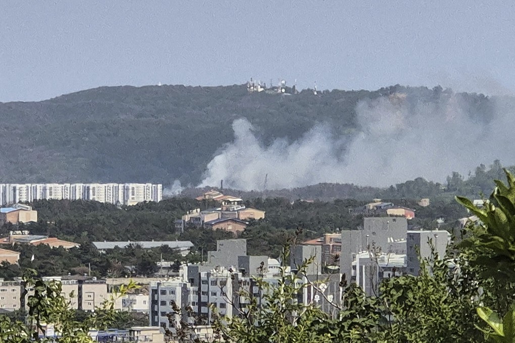 Smoke rises from a mountain in South Korea’s Pohang, where a navy plane crashed on Thursday. Photo: Yonhap via AP