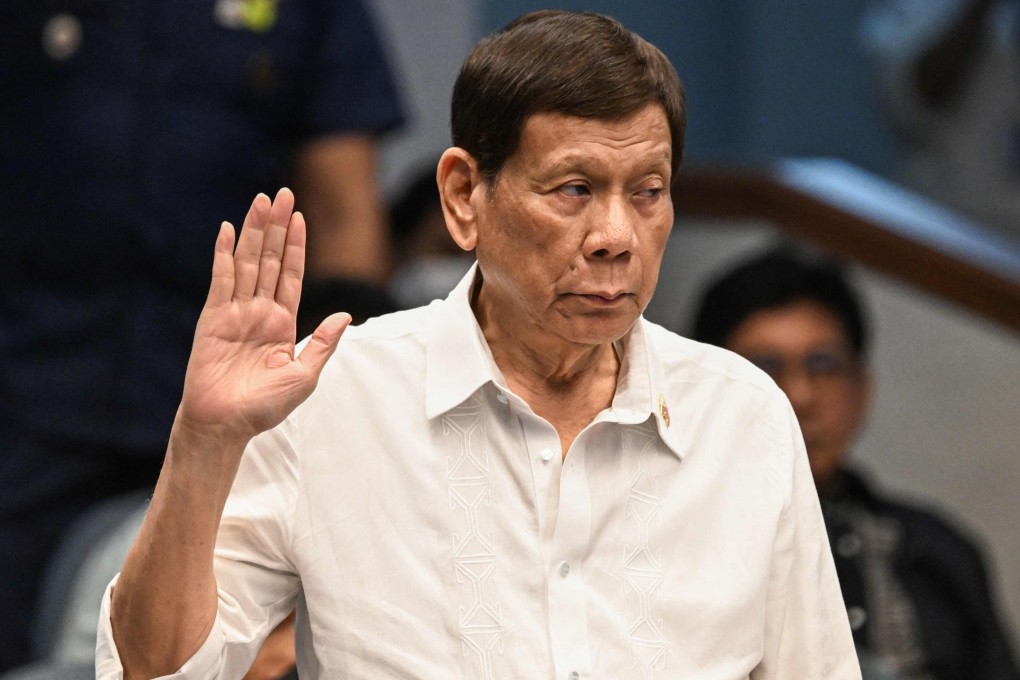 Former Philippine president Rodrigo Duterte takes an oath as he attends a Senate investigation into his drug war last year. Photo: AFP