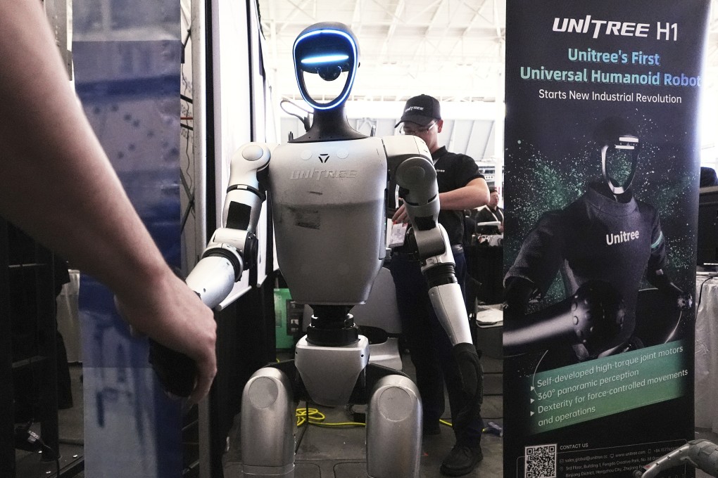 A Unitree robot shakes hands with a convention guest at the Robotics Summit & Expo, April 30, 2025, in Boston. Photo: AP