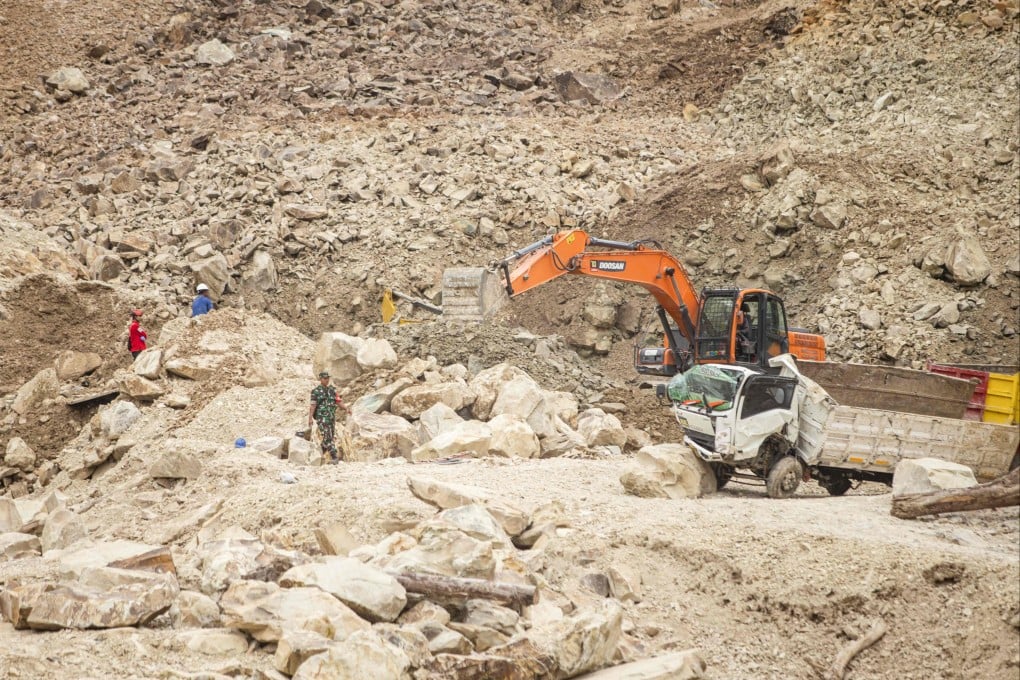Rescuers use heavy equipment to search for landslide victims on Friday. Photo: AFP