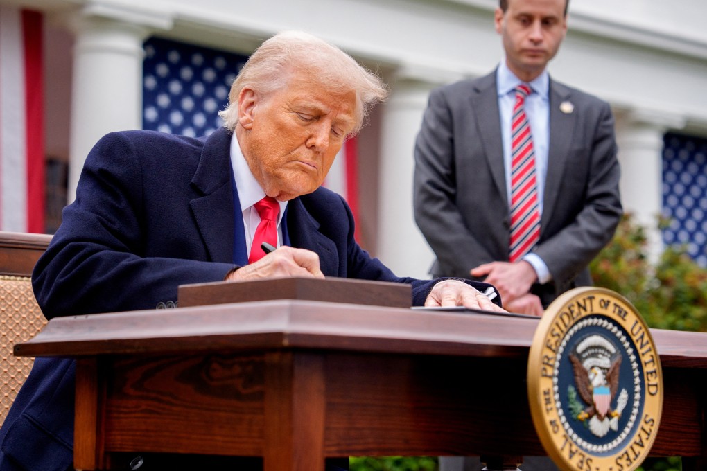 US President Donald Trump signs executive orders imposing tariffs on imported goods during a “Make America Wealthy Again” trade announcement on April 2 in Washington. Photo: AFP