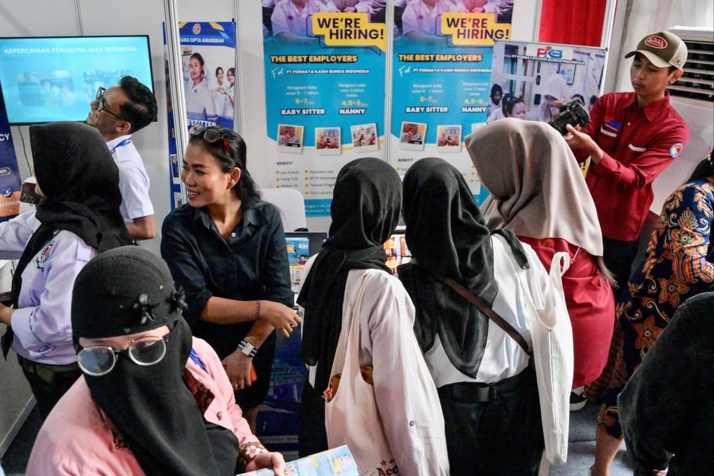 Jobseekers speak directly with representatives from companies they are interested in during a job fair in Jakarta on May 22. Photo: AFP