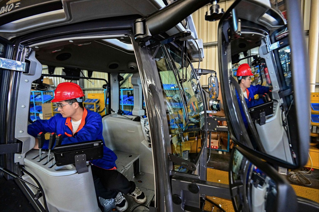 A tractor assembly line at a factory in eastern China’s Shandong province. Non-manufacturing PMI for May stayed above the 50-mark separating growth from contraction. Photo: AFP