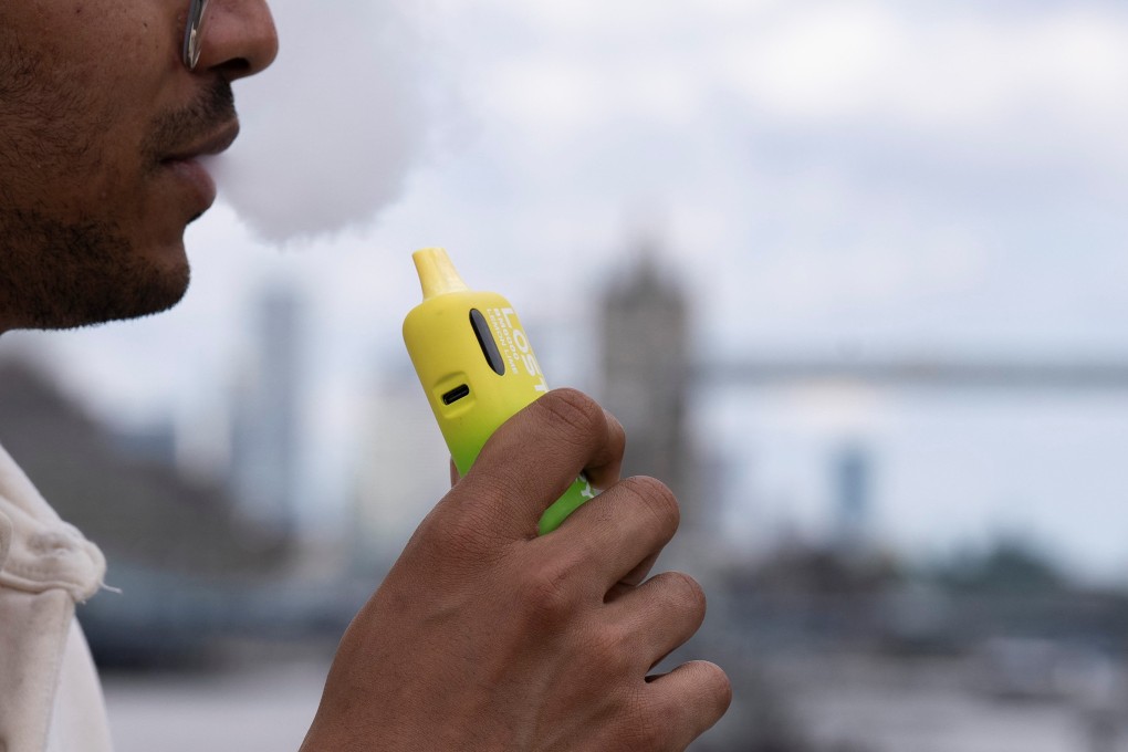 A man holds a disposable vape near London Bridge on Friday. Photo: Reuters