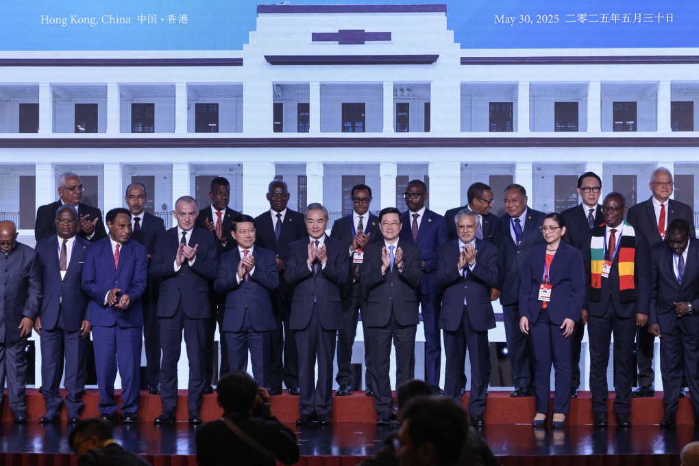 Chinese Foreign Minister Wang Yi (sixth from left) and Chief Executive John Lee Ka-chiu (seventh from left) attend the signing ceremony for the mediation centre on Friday. Photo: Nora Tam