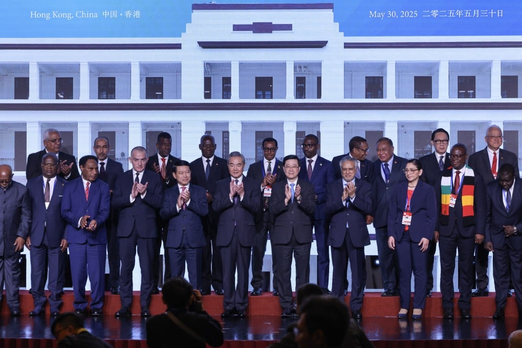 Chinese Foreign Minister Wang Yi (sixth from left) and Chief Executive John Lee Ka-chiu (seventh from left) attend the signing ceremony for the mediation centre on Friday. Photo: Nora Tam