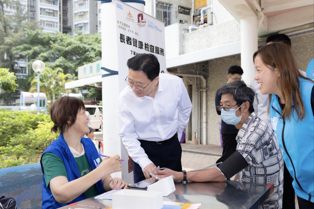 Liaison office director Zhou Ji (centre) visits a community centre in Tsing Yi. Photo: Handout