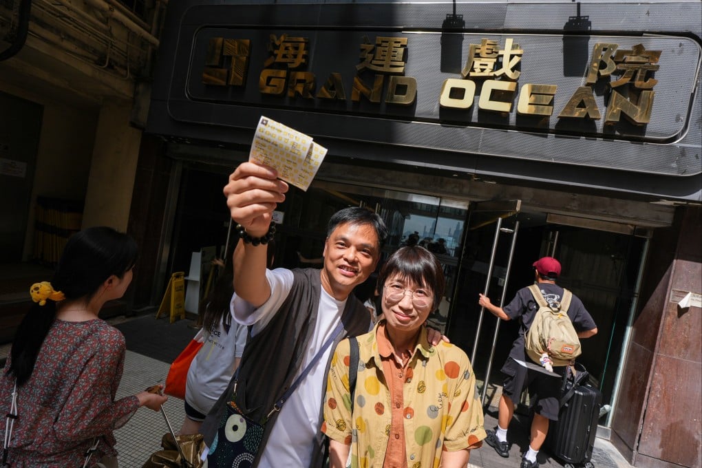 Wong Kai-Yu and his wife Joey Chow pose for a photo with their movie tickets outside Grand Ocean Cinema in Tsim Sha Tsui ahead of it closing after 56 years. Photo: Eugene Lee