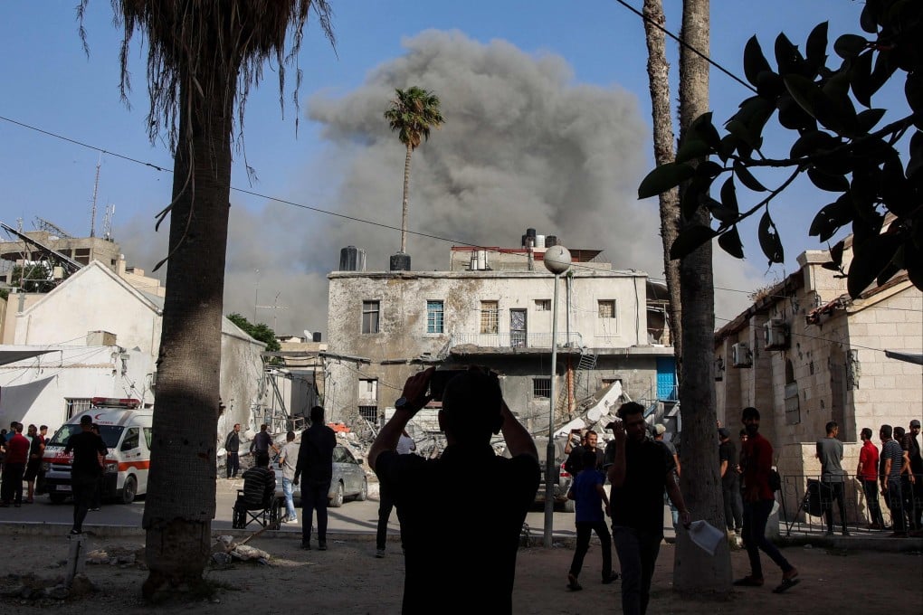 A cloud of smoke erupts amid Israeli bombardment on a building in the Daraj neighbourhood of Gaza City on Saturday. Photo: AFP