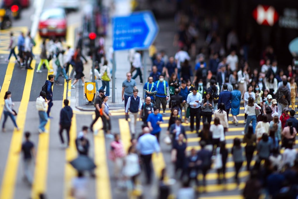Hongkongers at a pedestrian crossing in Central. The eMPF will ultimately allow 12 service providers, 367,000 employers and 4.75 million members to manage fund assets worth HK$1.326 trillion. Photo: Eugene Lee