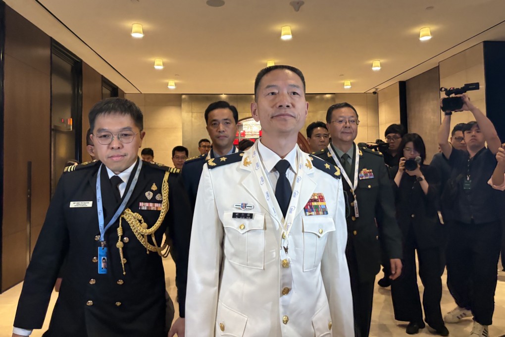 Hu Gangfeng (centre), a PLA major general and leader of China’s delegation to the Shangri-La Dialogue in Singapore, arrives for the forum’s opening ceremony on Friday. Photo: Hayley Wong