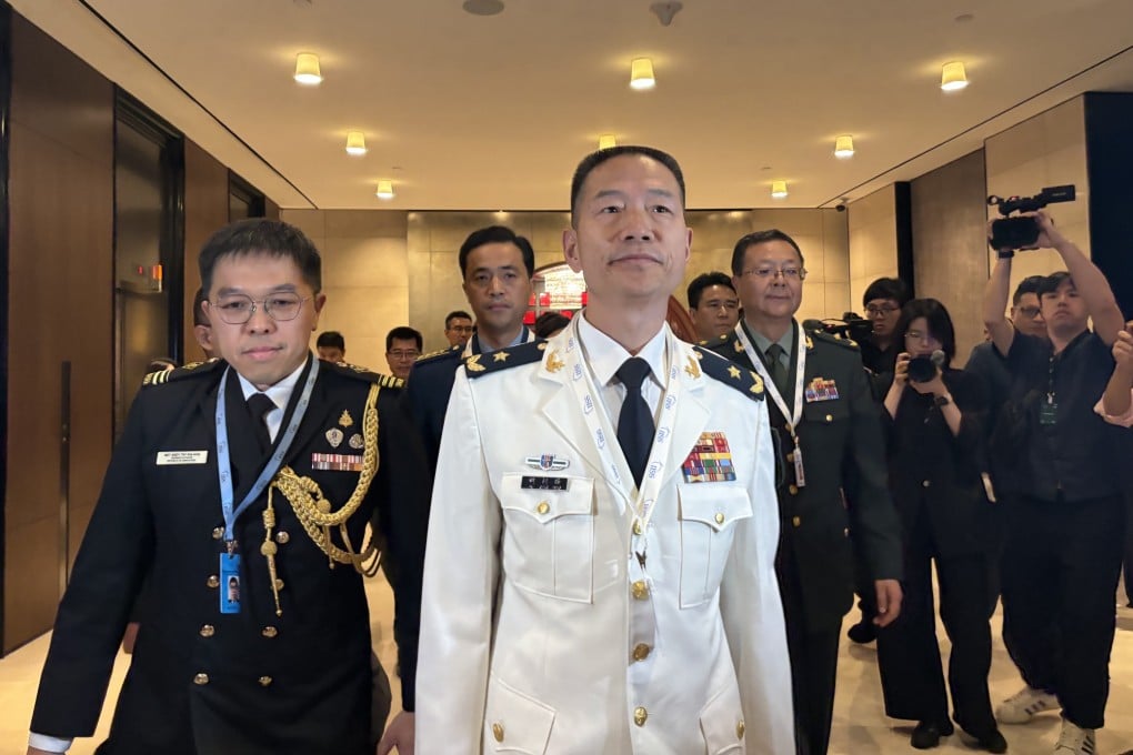 Hu Gangfeng (centre), a PLA major general and leader of China’s delegation to the Shangri-La Dialogue in Singapore, arrives for the forum’s opening ceremony on Friday. Photo: Hayley Wong