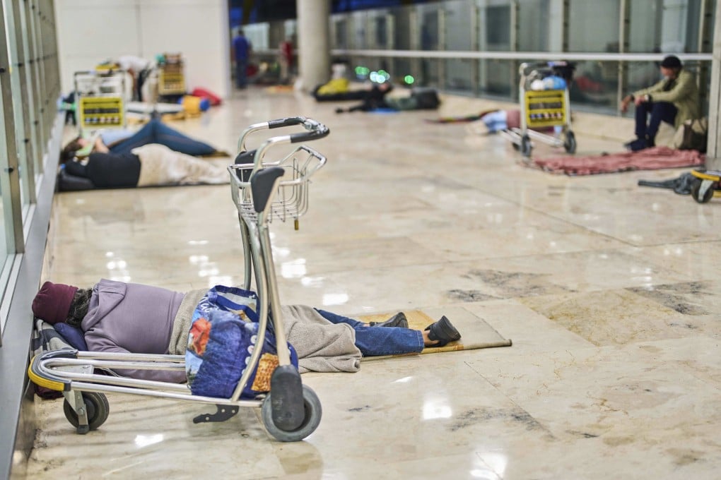 People sleep on the floor of Terminal 4 at Adolfo Suarez-Madrid Barajas Airport in Madrid, Spain. Photo: AP