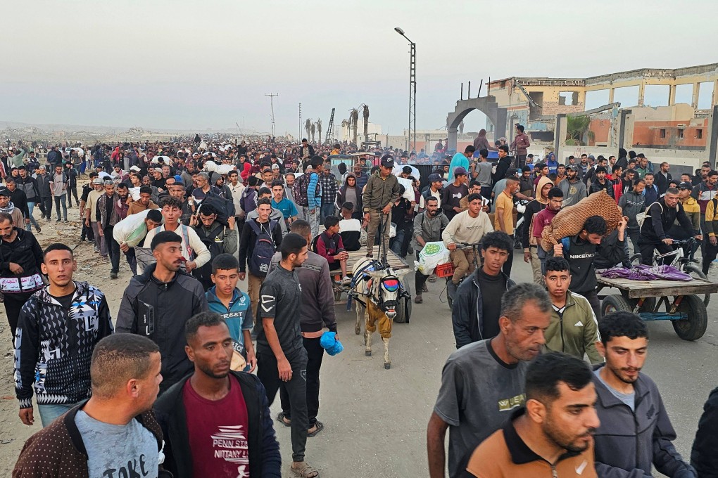 Displaced Palestinians return from a food distribution centre in Rafah in the southern Gaza Strip on Sunday. Gaza rescuers said Israeli gunfire killed several people. Photo: AFP
