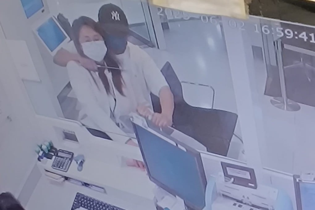 A screen grab of CCTV footage circulating online shows the robber holding a knife at the bank worker’s throat. Photo: Handout